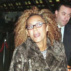 Mel B of the Spice Girls showing the two rings in her tongue as she went through Heathrow