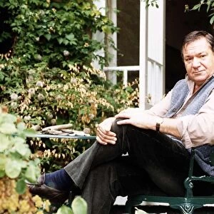 Michael Elphick Actor sitting in chair at home in garden