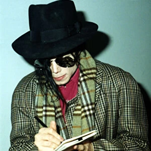 Michael Jackson signs an autograph at London airport. 7th October 1992