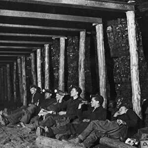 Miners down a mine shaft sitting eating drinking and Smoking in the shaft in Whitehill