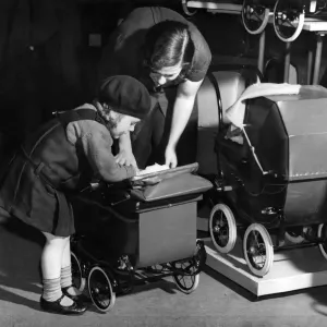 Little Girl with Doll in Pram Print, December 1934 Little Girl with Doll in Pram Print, December 1934