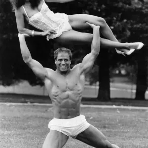 Linda Lusardi Lifted by Strongman Julien Moss Print Linda Lusardi Lifted by Strongman Julien Moss Print