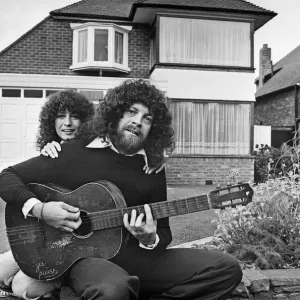 Print of Jeff Lynne sitting in a driveway with an acoustic guitar