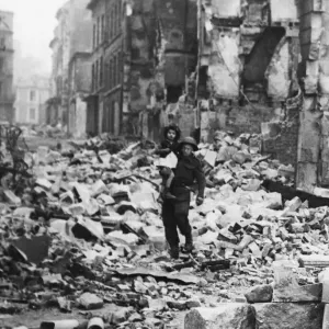 Print of a British soldier carrying a little girl through the ruins of Caen Print of a British soldier carrying a little girl through the ruins of Caen
