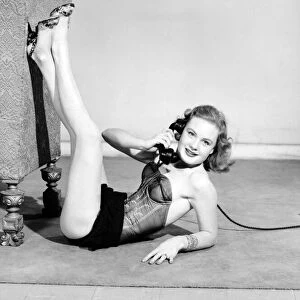 Model wearing underwear on telephone. July 1956 E227-004