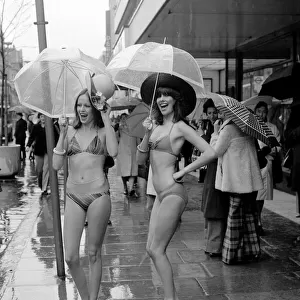 Models Wendy and Jackie seen here modeling the latest in swimwear on a wet Oxford Street
