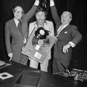 Morecambe and Wise present Des O Connor with a golden disc to mark 100000 sales of