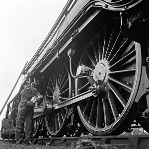 Mr Alan Pegler pictured cleaning the wheels of The Flying Scotsman engine