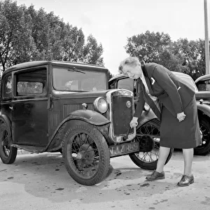 Mrs Goul attempting to start her motor car by using the starting handle
