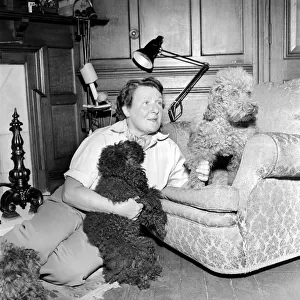 Mrs. Moss seen here with her dogs. 1954 A145b-001