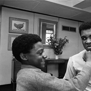 Muhammad Ali with a young fan at the Albany Hotel in Birmingham. 1st May 1984