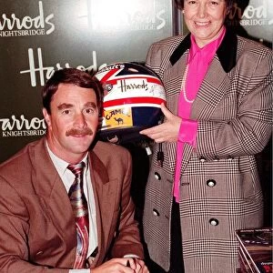 NIGEL MANSELL AND WOMAN AT HARRODS PROMOTION HOLDING A DRIVING HELMET 08 / 12 / 1992