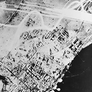 This night photographs show direct hits scored by British bombers on Tobruk jetties
