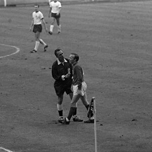 Nobby Stiles is spoken to the referee 30th July 1966. as Alan Ball makes a point