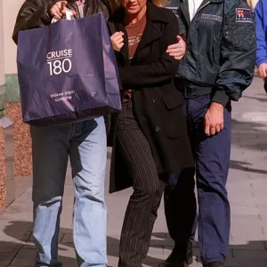 Noel Gallagher of the pop group Oasis with his girlfriend Meg Matthews outside