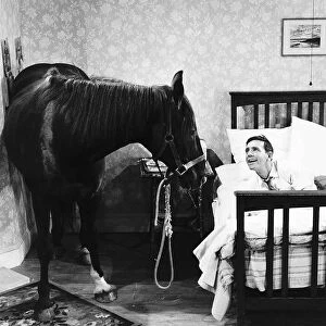 Norman Wisdom Comedian Actor with Nellie the Horse in a scene from the film "