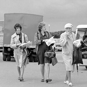 Old ladies enjoying fish and chips during a day out to the beach at Trecco Bay