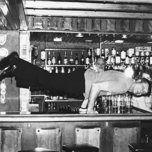 Oliver Reed actor doing press-ups on the bar at the Jamaica Inn Guernsey Currently