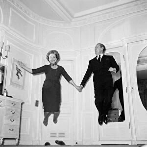 Olivia De Havilland playing a jumping game with her husband Pierre Galante
