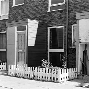 Painted council houses and the unpainted ones - part of a battle of home buying at a