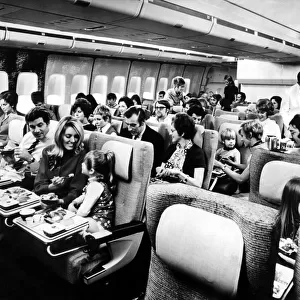 Passengers relax in the spacious interior of a Boeing 747 Jumbo Jet