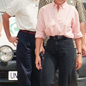 Paul Burrell (left, in the background in the white shirt and black trousers
