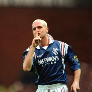 Paul Gascoigne of Rangers Football Club with his finger up to his mouth making a sign to