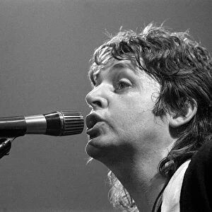 Paul McCartney, formerly of The Beatles, singing with his group Wings in concert in USA