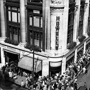 People queue outside Howells department store, St Mary Street, Cardiff. 7th August 1958