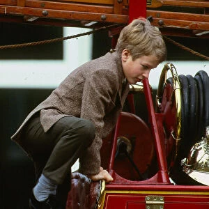 Peter Phillips January 1988 son of Princess Anne scrambles over top of old fire