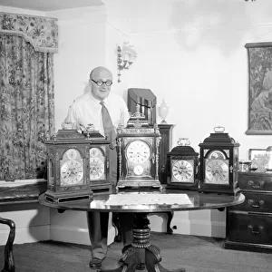 Peter Yorke, orchestra leader seen here with a collection of clocks June 1957