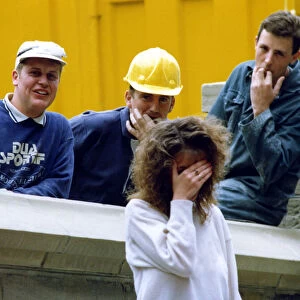 A picture showing the stereotypical behaviour of workmen wolf whistling pretty girls