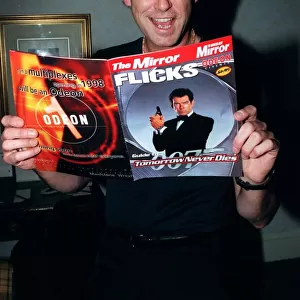 Pierce Brosnan 007 star with a copy of the December 1997 Mirror Flicks Magazine