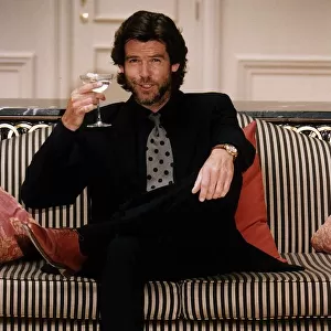 Pierce Brosnan Actor with a glass of Champagne