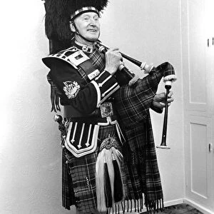 A piper smarly dressed in his uniforn and ready to play the bagpipes in March 1982