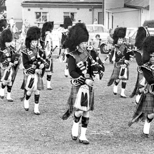 The pipes and drums of the Newcastle City Pipe Band opening a summer fayre in July 1981