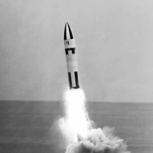 A Polaris A-3 missile ignites its main rocket motor after being launched from the USS