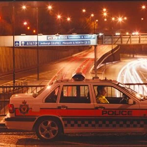 A police officer watches the traffic whizz by in his patrol car 01 / 06 / 95 circa