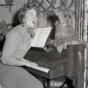 Polly the singing poodle seen here in full voice singing along with her owner