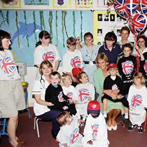 Princess Diana with six year old Jamie Poore sitting on her knee during a visit to a