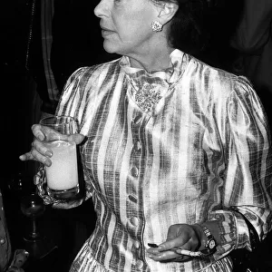 Princess Margaret smoking with cigarette holder and drinking orange at the Pye TV awards