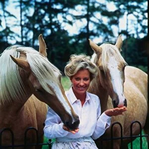 Princess Michael of Kent October 1986 leaning on railings feeding horses