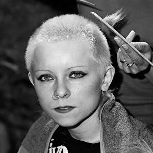 Punk girl Julie Brandon having her hair cut by her mother at their home in Thame