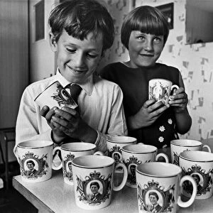 Pupils Ian Graves and Julie Radford admire the mugs presented by Cardiff City Council to
