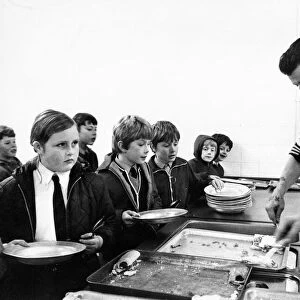 Pupils queue to by served their school dinner