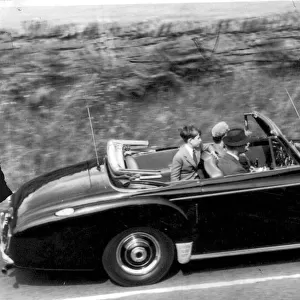 Queen Elizabeth II and The Duke of Edinburgh with Prince Charles driving in their car