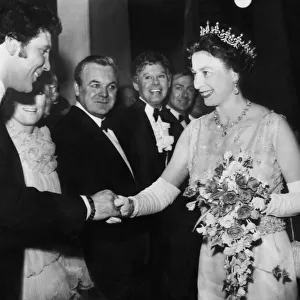 The Queen shaking hands with Tom Jones at the Royal Variety Show at the London Palladium