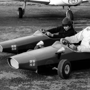 Racing driver Graham Hill races son Damon in their toy cars, at Elstree aerodrome 1971