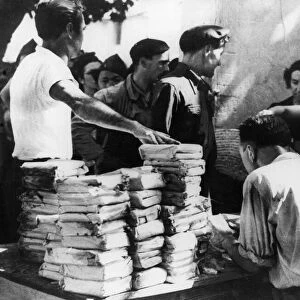 Rations abandoned by the retreating Germans in Southern France being distributed to