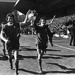 Ray Clemence and Larry Lloyd of Liverpool parade the League Championship trophy following